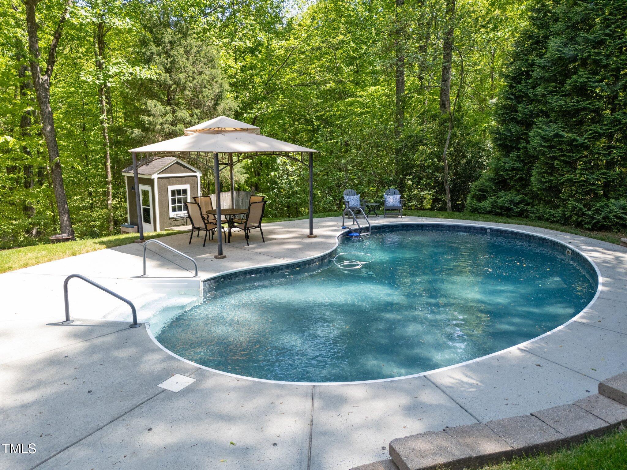 12200 Glenlivet Way Raleigh, NC 27613 - Photo 38 of 51 a view of a swimming pool with a outdoor seating