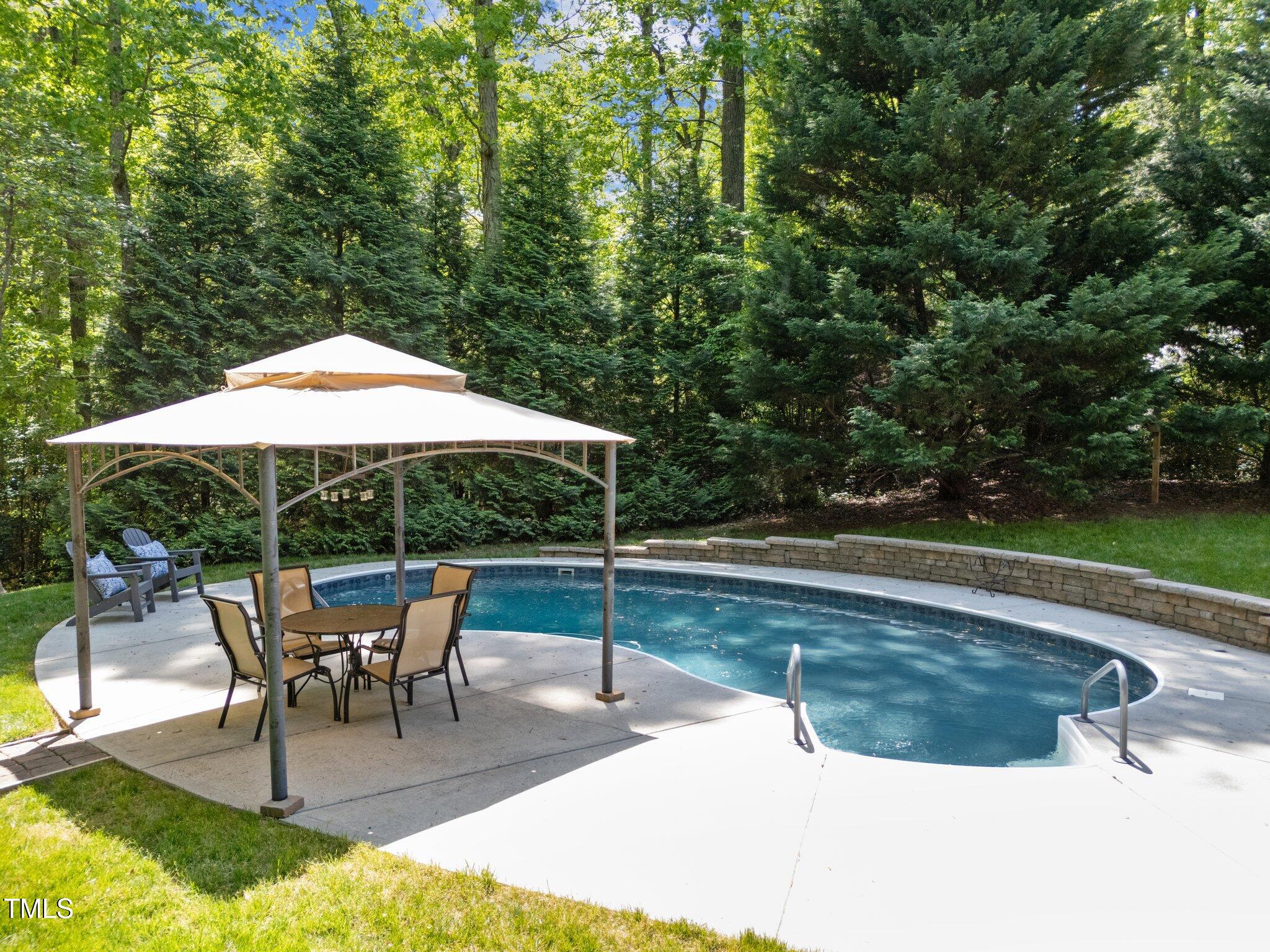 12200 Glenlivet Way Raleigh, NC 27613 - Photo 41 of 51 a swimming pool with outdoor seating yard and barbeque oven
