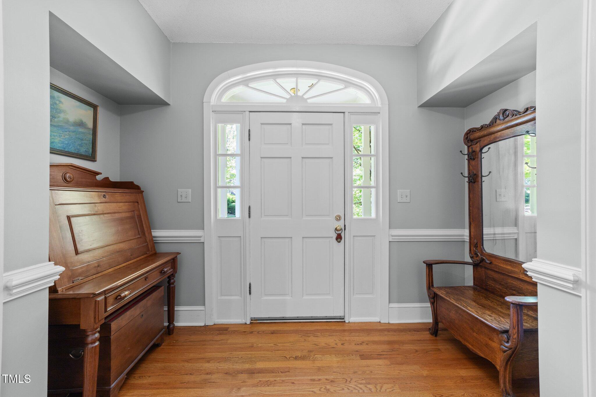 12200 Glenlivet Way Raleigh, NC 27613 - Photo 3 of 51 a view of a livingroom with wooden floor and furniture