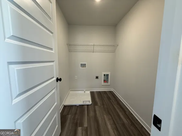 a view of a room with wooden floor