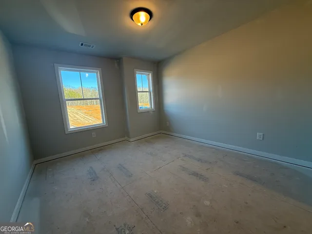 a view of a hallway with a sink and a mirror