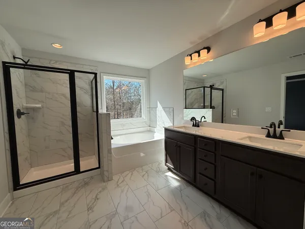 a spacious bathroom with a double vanity sink a mirror and a shower