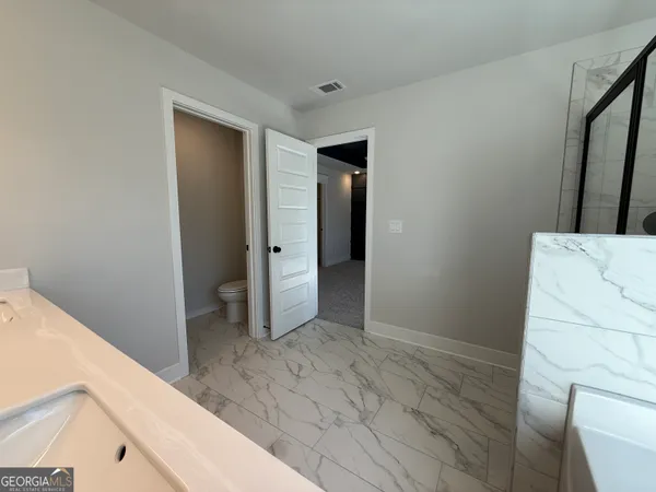 a view of a bathroom from a hallway