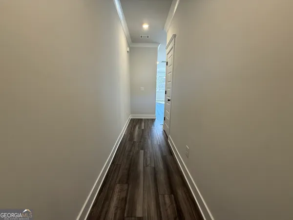 a view of a hallway with wooden floor