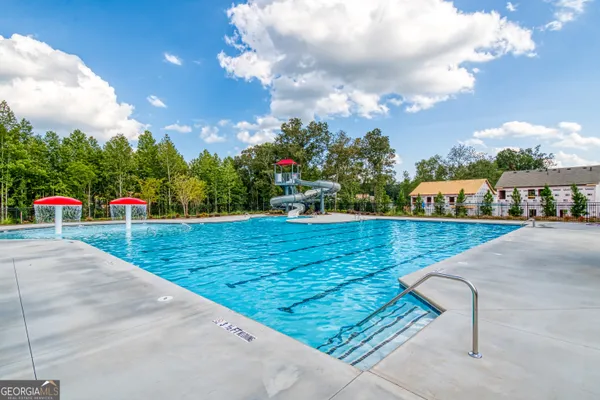 a view of a house with swimming pool yard and outdoor seating