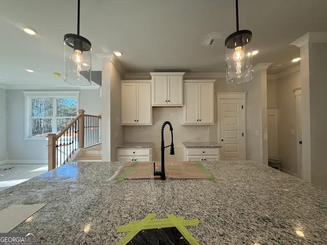 a view of a kitchen and kitchen area a sink wooden floor