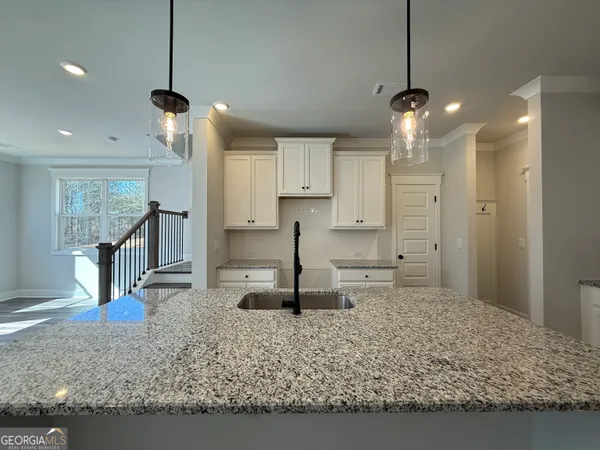 a large kitchen with stainless steel appliances kitchen island a stove a refrigerator and a sink