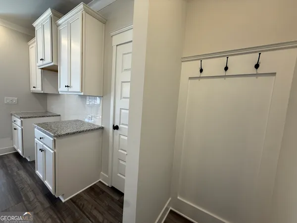 a utility room with cabinets washer and dryer