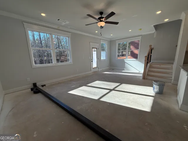 a living room with hardwood floor and a ceiling fan