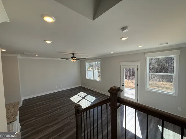 a view of entryway and hall with wooden floor
