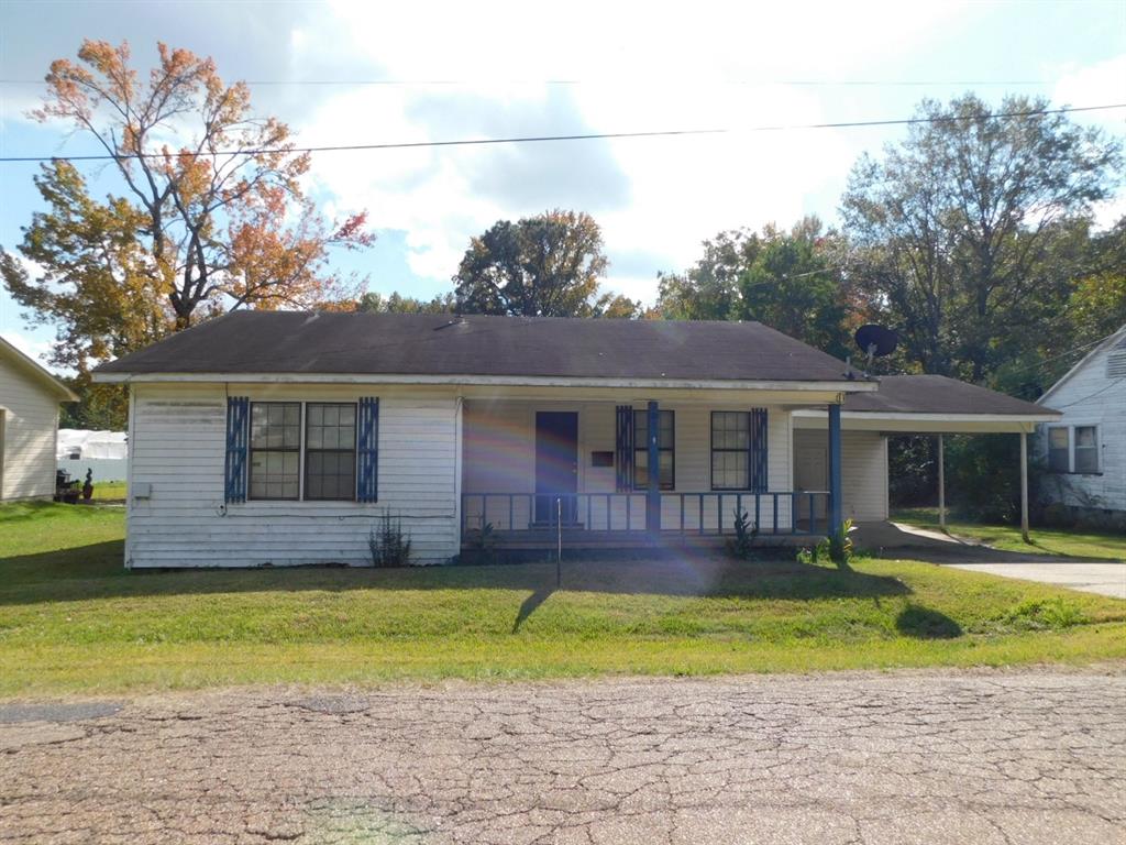 a front view of a house with a yard table and chairs