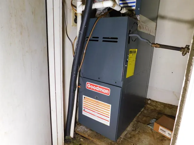 a view of an empty room with wooden floor and a ceiling fan