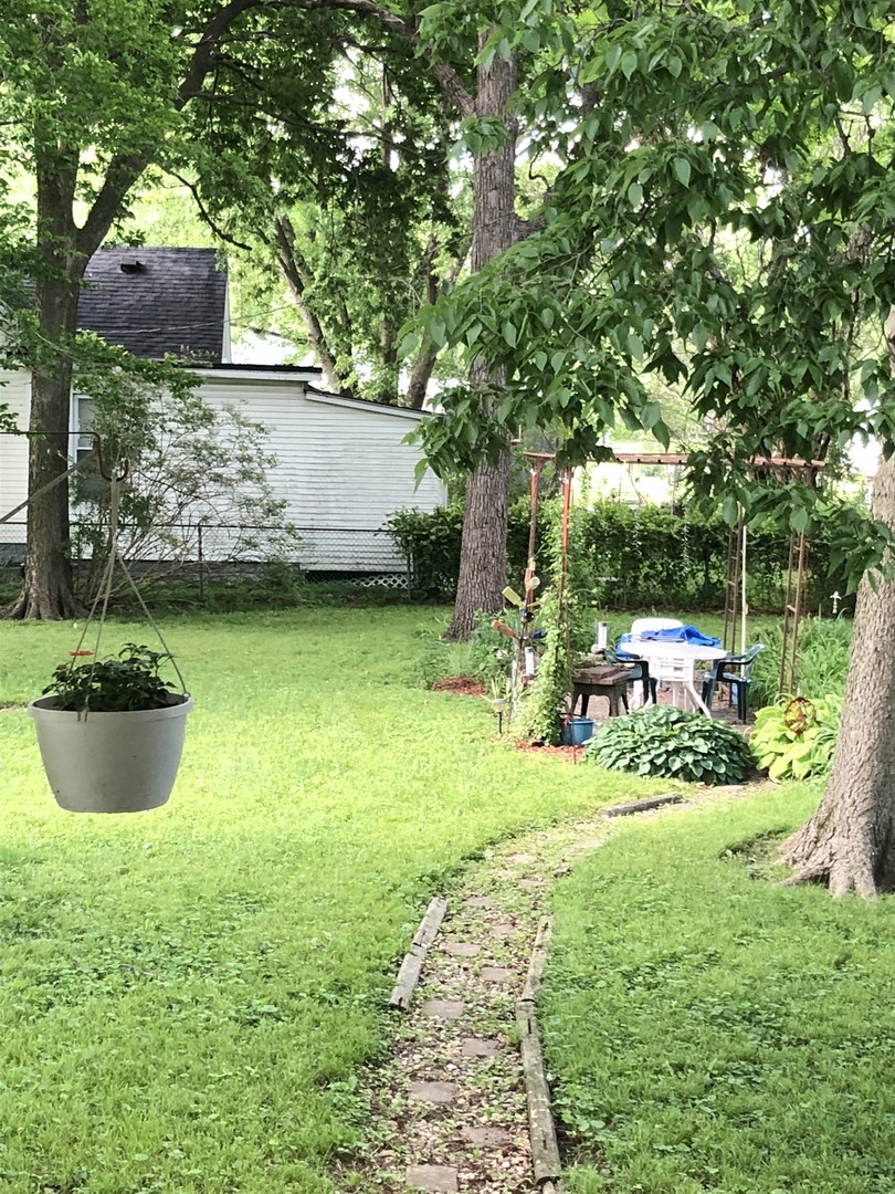 403 East 3rd Street Brocton, IL 61917 - Photo 38 of 39 a view of a backyard with table and chairs and potted plants