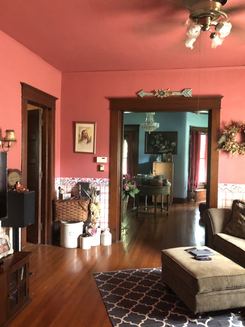 403 East 3rd Street Brocton, IL 61917 - Photo 8 of 39 a living room with furniture and a chandelier