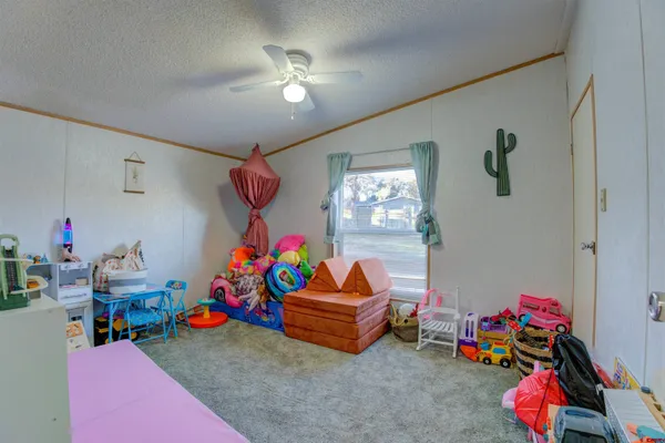 a bedroom with a bed and a refrigerator