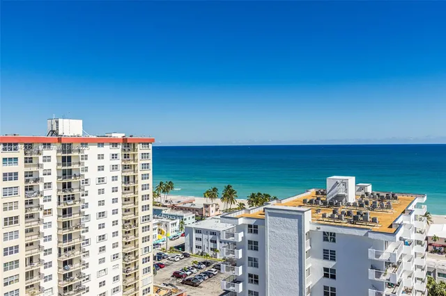a view of swimming pool with outdoor seating and city view