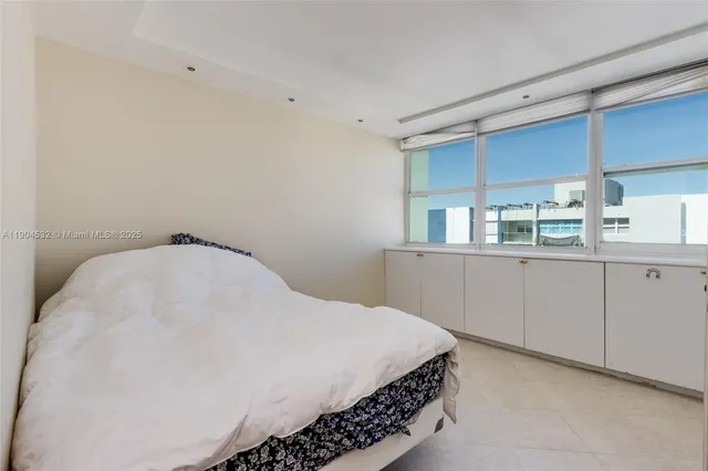 a large bed in a white room
