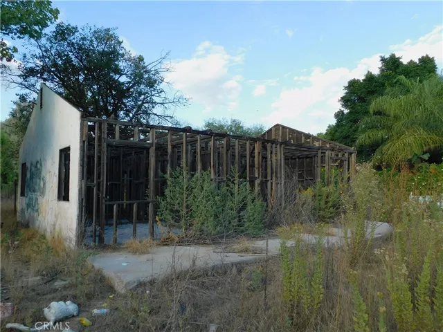 a view of a porch with a table and chairs
