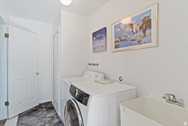 5321 South 3100th Street West Roy, UT 84067 - Photo 51 of 64 Dedicated laundry area featuring a front-load washing machine, a top-load washing machine, and a utility sink with a chrome faucet