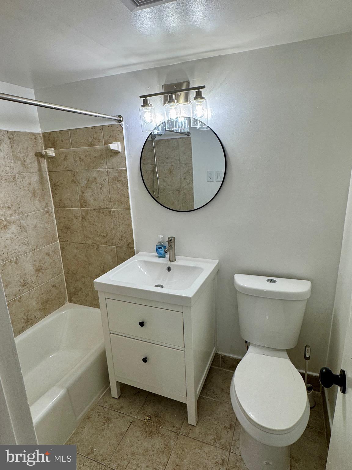 3811 Swann Road, Unit 102 Suitland, MD 20746 - Photo 10 of 10 a bathroom with a toilet sink and mirror