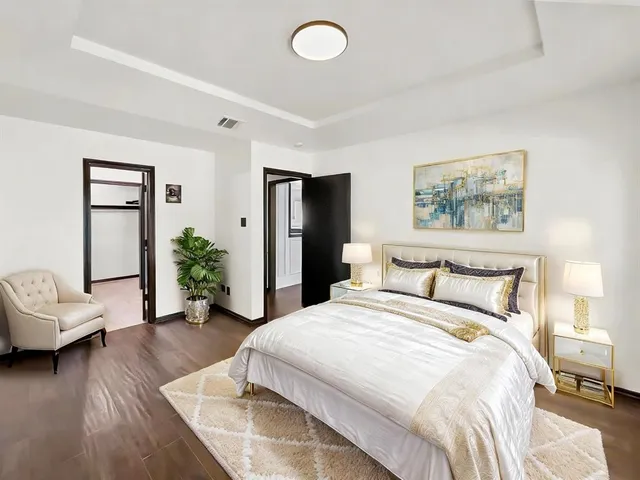 a spacious bedroom with a bed and a couch