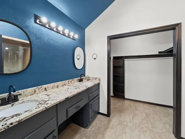 a room with a mirror and a sink