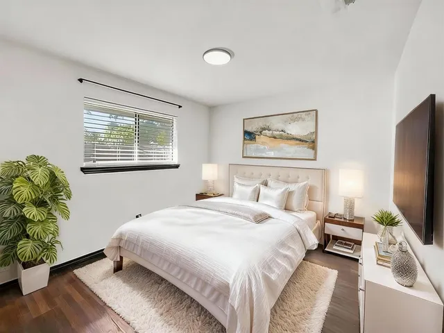 a bedroom with a bed and a flat screen tv