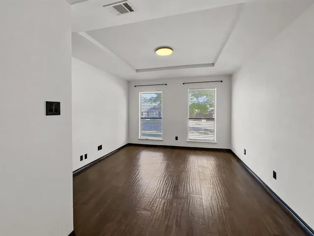 a view of a livingroom with wooden floor and window