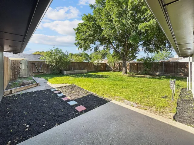 a view of a backyard with swimming pool