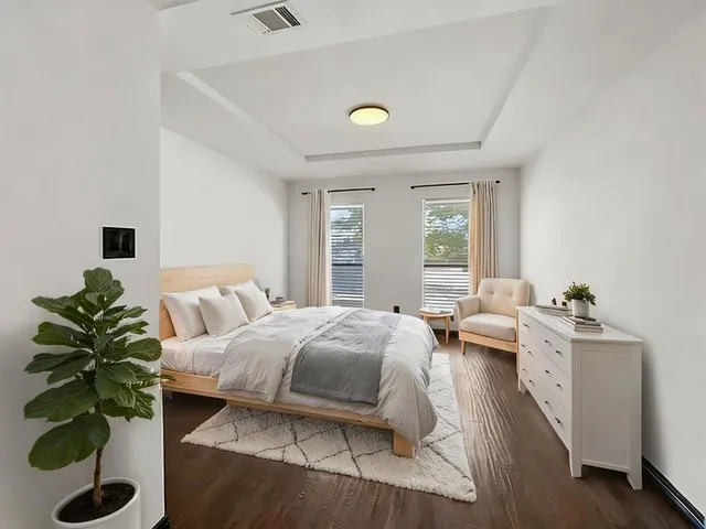 a bedroom with furniture and a potted plant