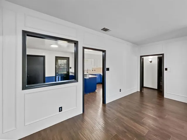 a kitchen with kitchen island wooden floors and stainless steel appliances