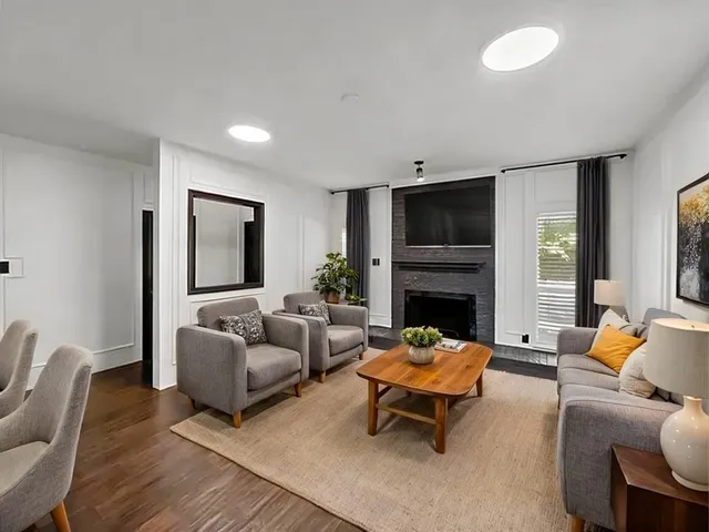 a living room with furniture flat screen tv and a fireplace