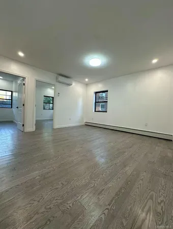 an empty room with a empty space and windows