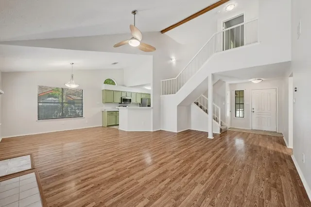 a view of empty room with wooden floor