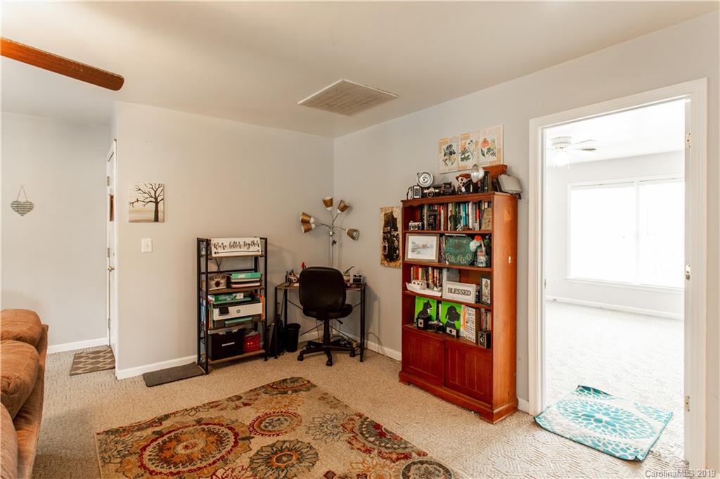 5520 Barrier Road Concord, NC 28025 - Photo 11 of 35 a bedroom with furniture and a book shelf