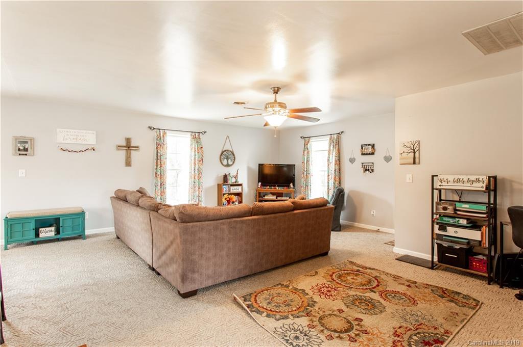 5520 Barrier Road Concord, NC 28025 - Photo 13 of 35 a living room with furniture and a flat screen tv