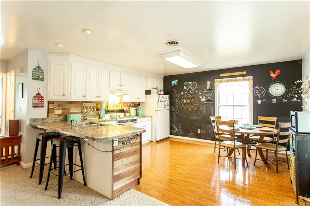 5520 Barrier Road Concord, NC 28025 - Photo 3 of 35 a kitchen with a table chairs stove and cabinets