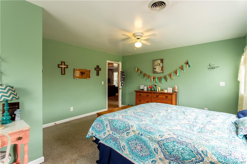 5520 Barrier Road Concord, NC 28025 - Photo 23 of 35 a bedroom with a bed and a chandelier
