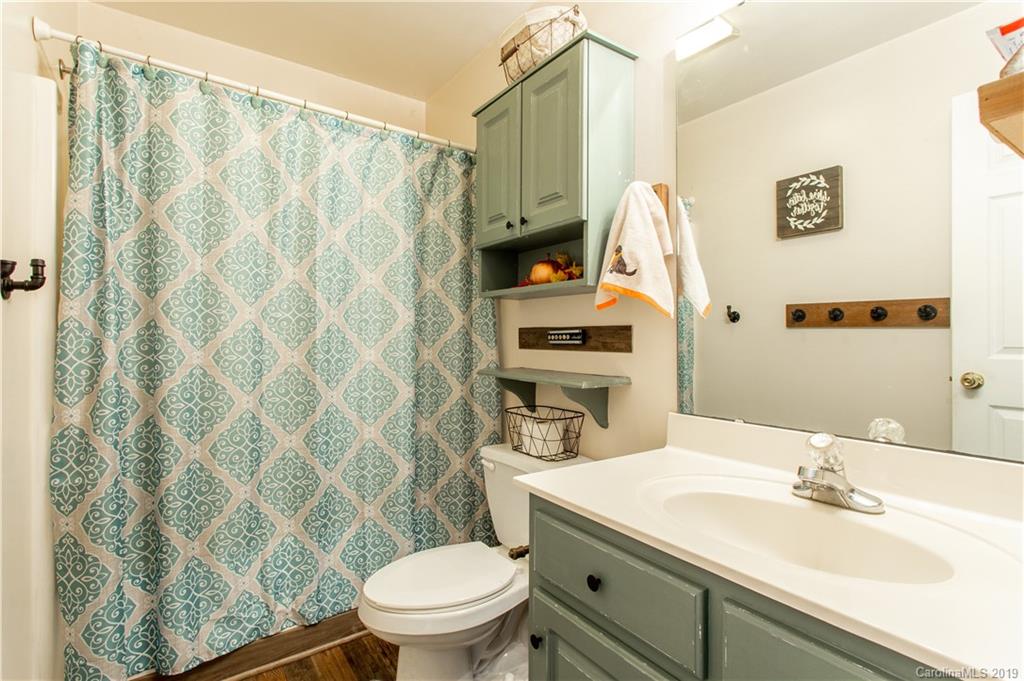 5520 Barrier Road Concord, NC 28025 - Photo 25 of 35 a bathroom with a granite countertop sink and a mirror