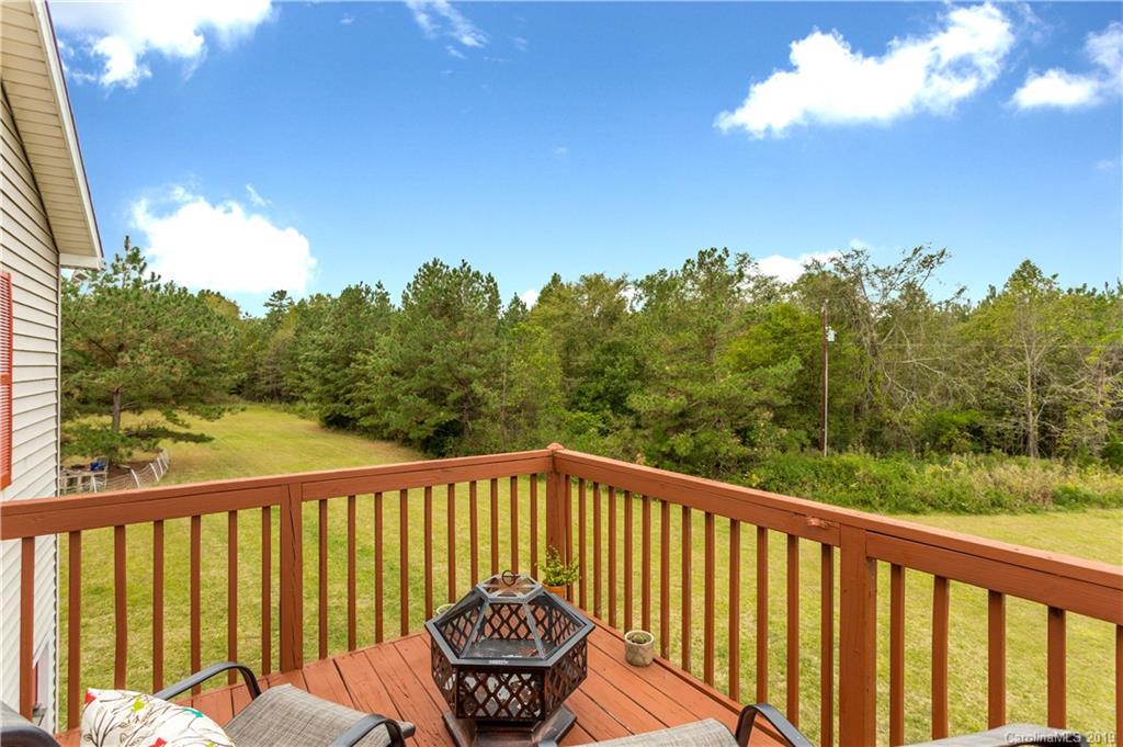 5520 Barrier Road Concord, NC 28025 - Photo 31 of 35 a balcony with wooden floor and yard in the back