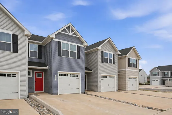 a kitchen with granite countertop a sink stove and refrigerator