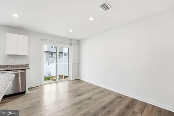 a view of kitchen with kitchen island and stainless steel appliances