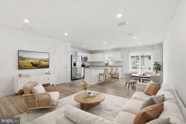 a living room with furniture kitchen view and a table