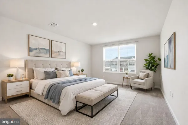 a bedroom with a bed and a couch