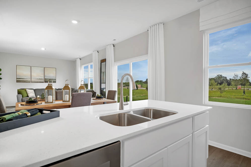 402 Arbor Ridge Court Hampshire, IL 60140 - Photo 10 of 47 a kitchen with stainless steel appliances granite countertop a sink a counter space and a view of living room