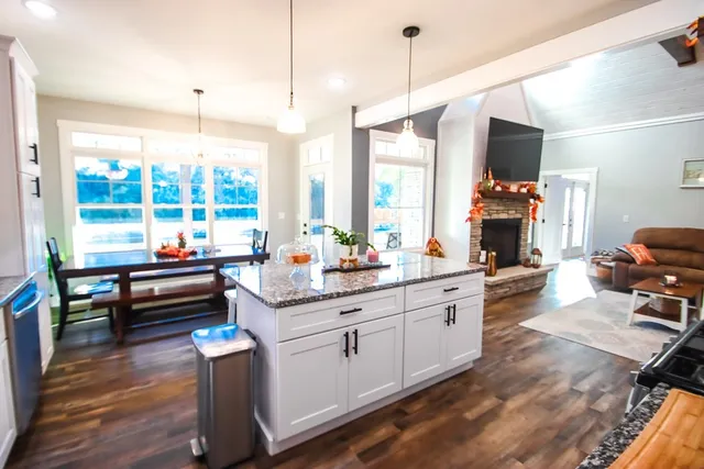 a living room with furniture and a floor to ceiling window