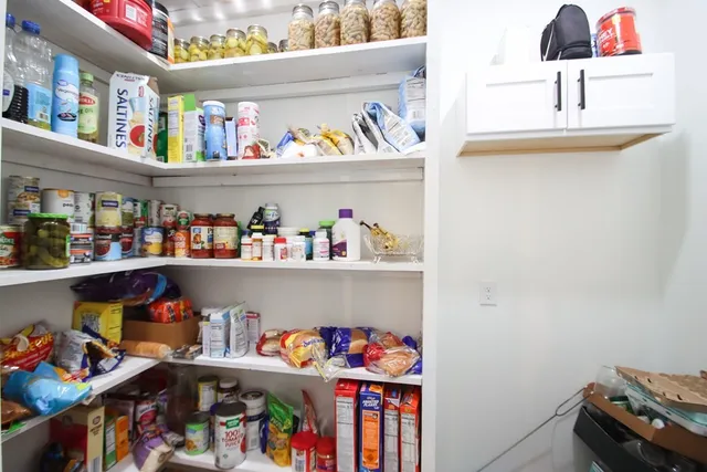 a view of a patio with table and chairs with wooden floor and fence