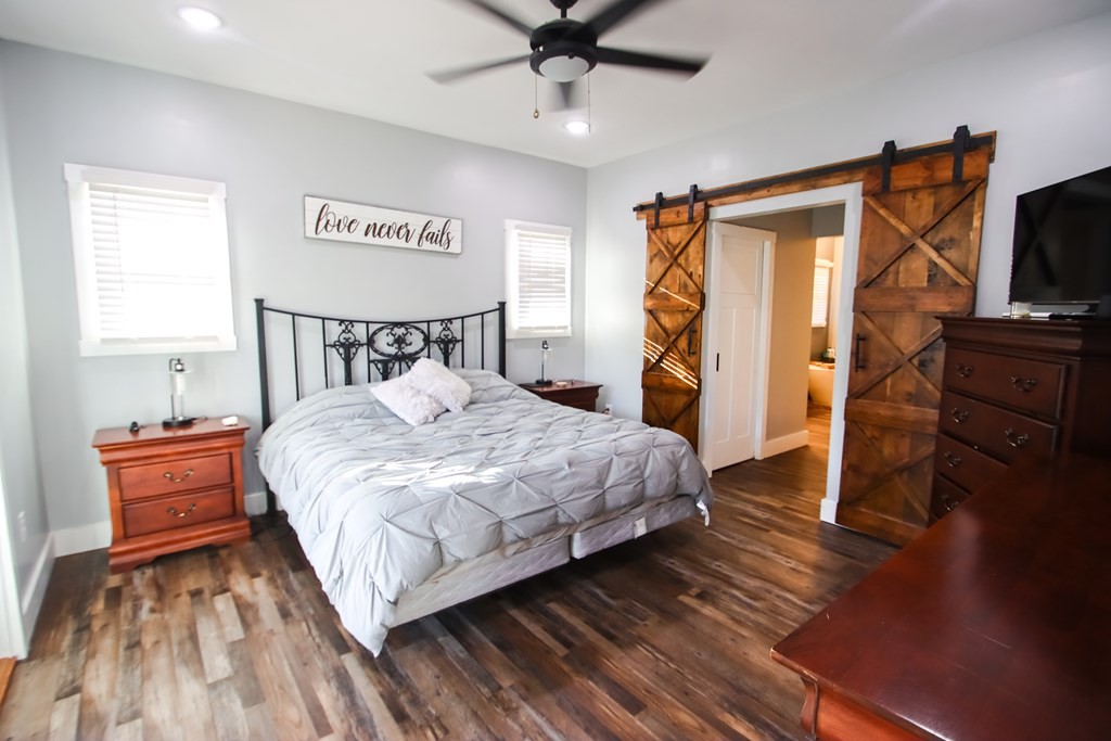 608 Lakeview Road Walling, TN 38587 - Photo 19 of 68 a bedroom with a bed and wooden floor