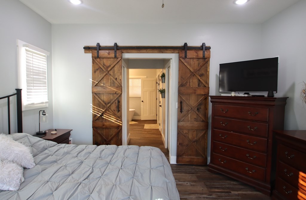 608 Lakeview Road Walling, TN 38587 - Photo 20 of 68 a bedroom with a bed and a flat screen tv