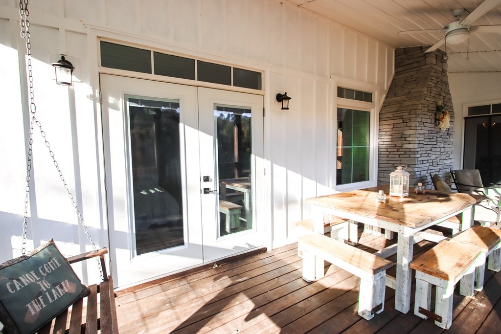 608 Lakeview Road Walling, TN 38587 - Photo 24 of 68 a view of a patio with table and chairs with wooden floor and fence